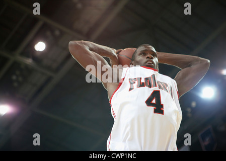 Basketball player shooting basketball, low angle view Stock Photo