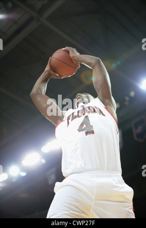 Basketball player jumping with basketball, low angle view Stock Photo