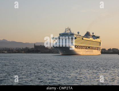 Cunard Line Cruise Ship 'Azura' arriving at early morning into the Port of Palma de Mallorca - with Palma historic cathedral Stock Photo