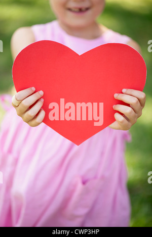 Girl holding paper heart, cropped Stock Photo