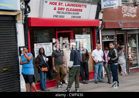 Multicultural street scenes in Walthamstow outside Laundrette in North London Stock Photo