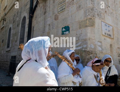 Ethiopian Christian pilgrims carry across along the Via Dolorosa in Jerusalem , Israel Stock Photo