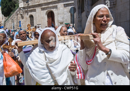 Ethiopian Christian pilgrims carry across along the Via Dolorosa in Jerusalem , Israel Stock Photo