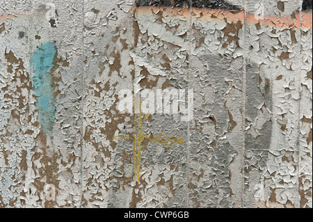 peeling paint and graffiti from concert pillar wall waterlogged vandalism Stock Photo