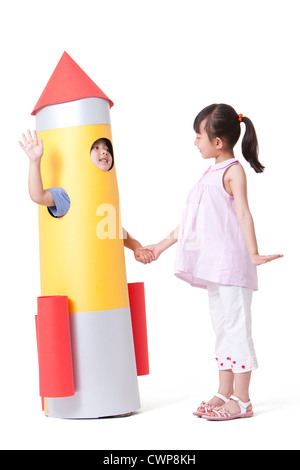 Boy holding rocket toy while standing on steps against sky Stock Photo ...