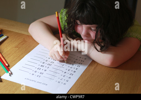 Little girl doing maths homework Stock Photo