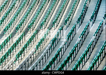 diagonal rows of empty green and white seating in sporting venue Stock Photo