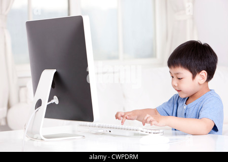 Boy using computer at home Stock Photo