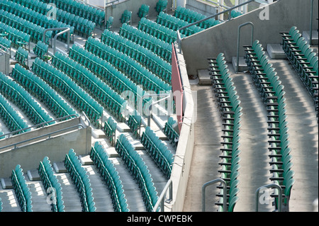 a section of empty light blue stadium seating at sporting venue Stock Photo