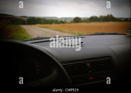 Spectacles on a car dashboard Weingarten Baden-Wuerttemberg Germany Stock Photo