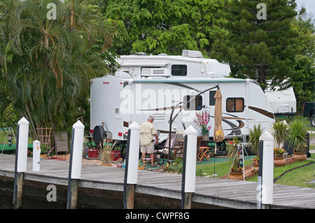 A cruise upriver of Fort Lauderdale's New River, takes boaters past luxurious homes, yachts, bustling city life, and campers. Stock Photo