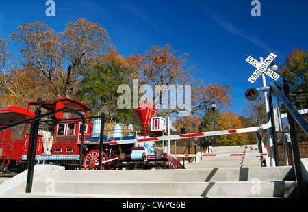 Raleigh, NC, North Carolina. Miniature train in Pullen park at railroad crossing. Stock Photo