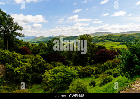 The extraordinary diverse terrain of the Lake District with its patchwork of fields surrounded by wooded slopes and rugged fells Stock Photo