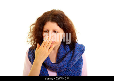 Young brown-haired woman with wool scarf sniffs the hand, isolated on white background, studio shot. Adobe RGB Stock Photo