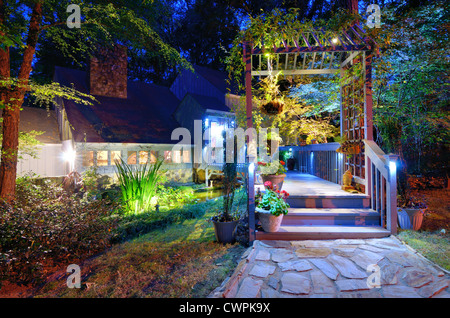 Walkway and front porch of a nice house in the woods. Stock Photo