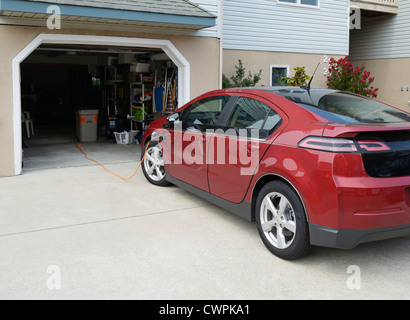 Chevrolet Volt, electric car, recharging at a suburban home Stock Photo