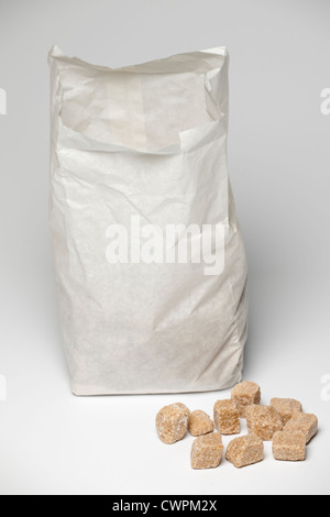 Bag of natural unrefined cane sugar Demerara rough cut cubes Stock Photo