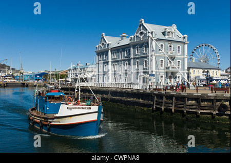 Fishing cutter and African Trading Port building at V&A Waterfront, Cape Town, South Africa Stock Photo