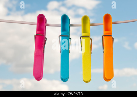 colorful plastic clothespins on a wire Stock Photo