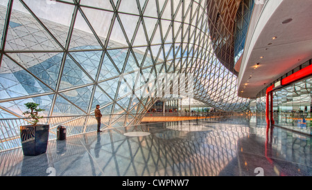 A man stands in a modern shopping mall designed by Massimiliano Fuksas in Germany Stock Photo