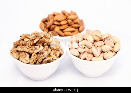 Bowl of Pistachios, almonds and wallnutes on white background Stock Photo