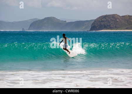 Indonesia, Lombok, South Coast, Seong Blanak, beach, young local surfer surfing Stock Photo