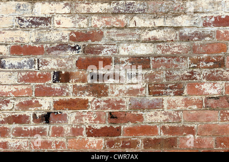 old brick wall texture background with worn off paint Stock Photo