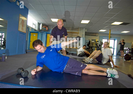 Swimming Coach Billy Pye training Paralympian swimmer David Roberts CBE in Swansea. Stock Photo