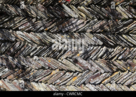 Herring bone style pattern forming decorative wall made of Cornish slate. St Mawes, Cornwall, UK Stock Photo