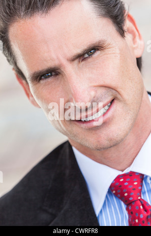 Portrait of successful businessman wearing suit and tie while standing ...