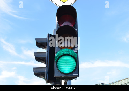Green color on traffic light with beautiful blue sky in background