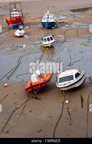 Boats beached at low tide in Tenby Harbour, Pembrokeshire, Wales, UK Stock Photo
