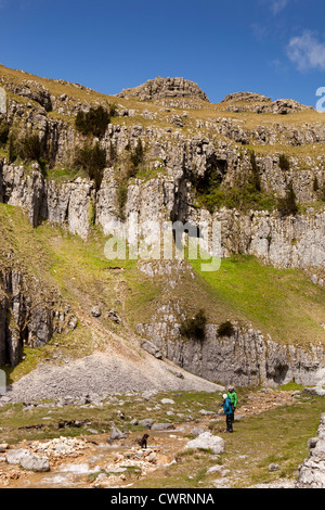 UK, England, Yorkshire, Malham, Gordale Scar, climbers with dog playing in Gordale beck Stock Photo