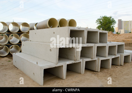 Materials used in road construction works. Concrete molds and plastic sewage pipes. Stock Photo