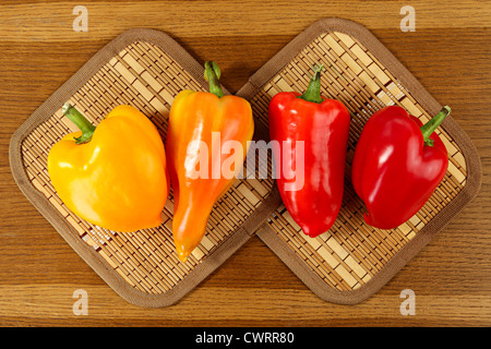 Bell peppers on an oak tabletop Stock Photo