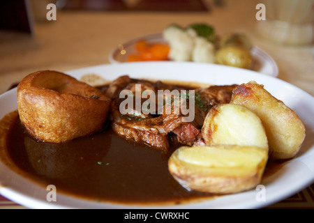 sunday roast dinner served in a pub featuring roast lamb potatoes yorkshire pudding vegetables and gravy scotland uk Stock Photo