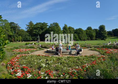 Children playing by fountain in Sunken Gardens, Priory Park, Reigate, Surrey, England, United Kingdom Stock Photo