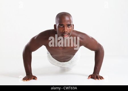 muscular young african american man doing push ups exercise against white background Stock Photo