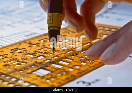 Architect working on architectural plans in the office Stock Photo