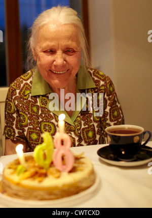 Kind grandmother is celebrating her 86th birthday at home. Stock Photo