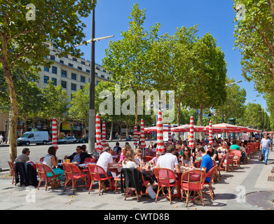 People sitting at a pavement cafe on the famous street the Champs Elysees avenue Paris France EU Europe Stock Photo