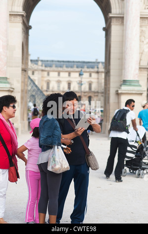 Paris France - Couple tourists using digital tablet Stock Photo