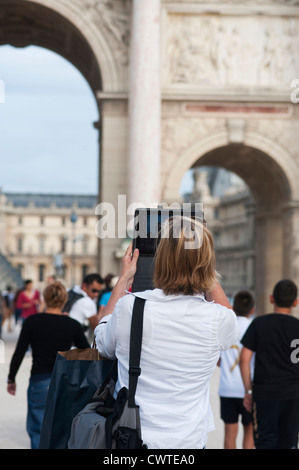 Paris, France - Woman taking photo using a digital tablet Ipad Stock Photo