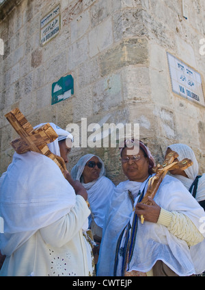 Ethiopian Christian pilgrims carry across along the Via Dolorosa in Jerusalem , Israel Stock Photo