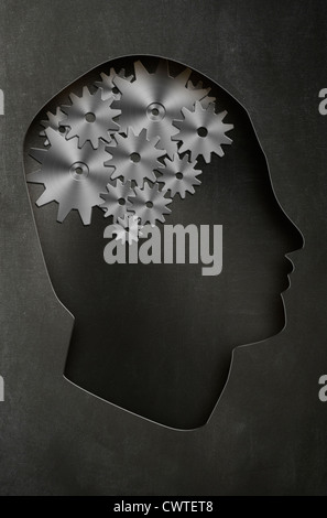 Profile of a man's head with a representation of the brain as cogs and gears. Concept image Stock Photo