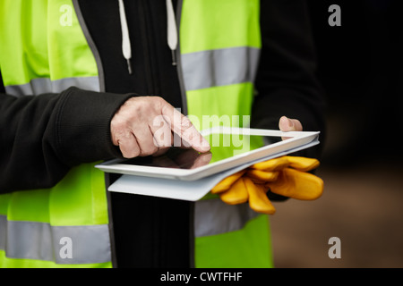 construction worker using digital tablet Stock Photo