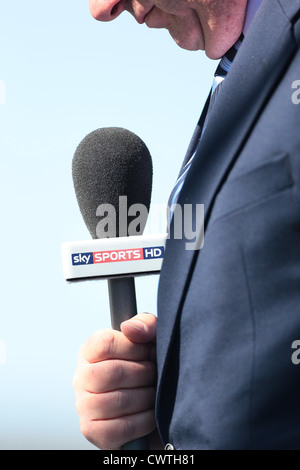 A Sky Sports reporter holds a Sky Sports HD microphone during a live broadcast. Picture by James Boardman. Stock Photo