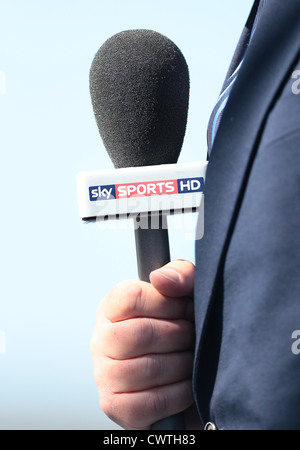 A Sky Sports reporter holds a Sky Sports HD microphone during a live broadcast. Picture by James Boardman. Stock Photo