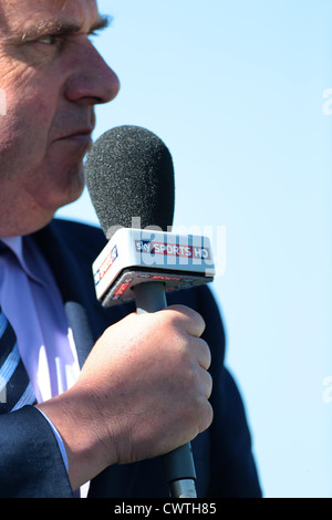 A Sky Sports reporter holds a Sky Sports HD microphone during a live broadcast. Picture by James Boardman. Stock Photo