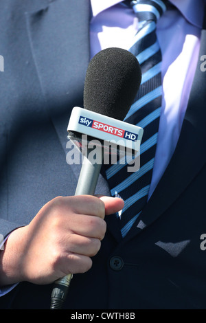 A Sky Sports reporter holds a Sky Sports HD microphone during a live broadcast. Picture by James Boardman. Stock Photo